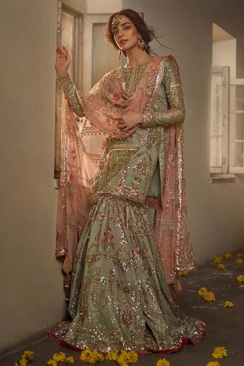 Gul- e- zamurd pakistani fashion outfit in gold, peach, red tones.