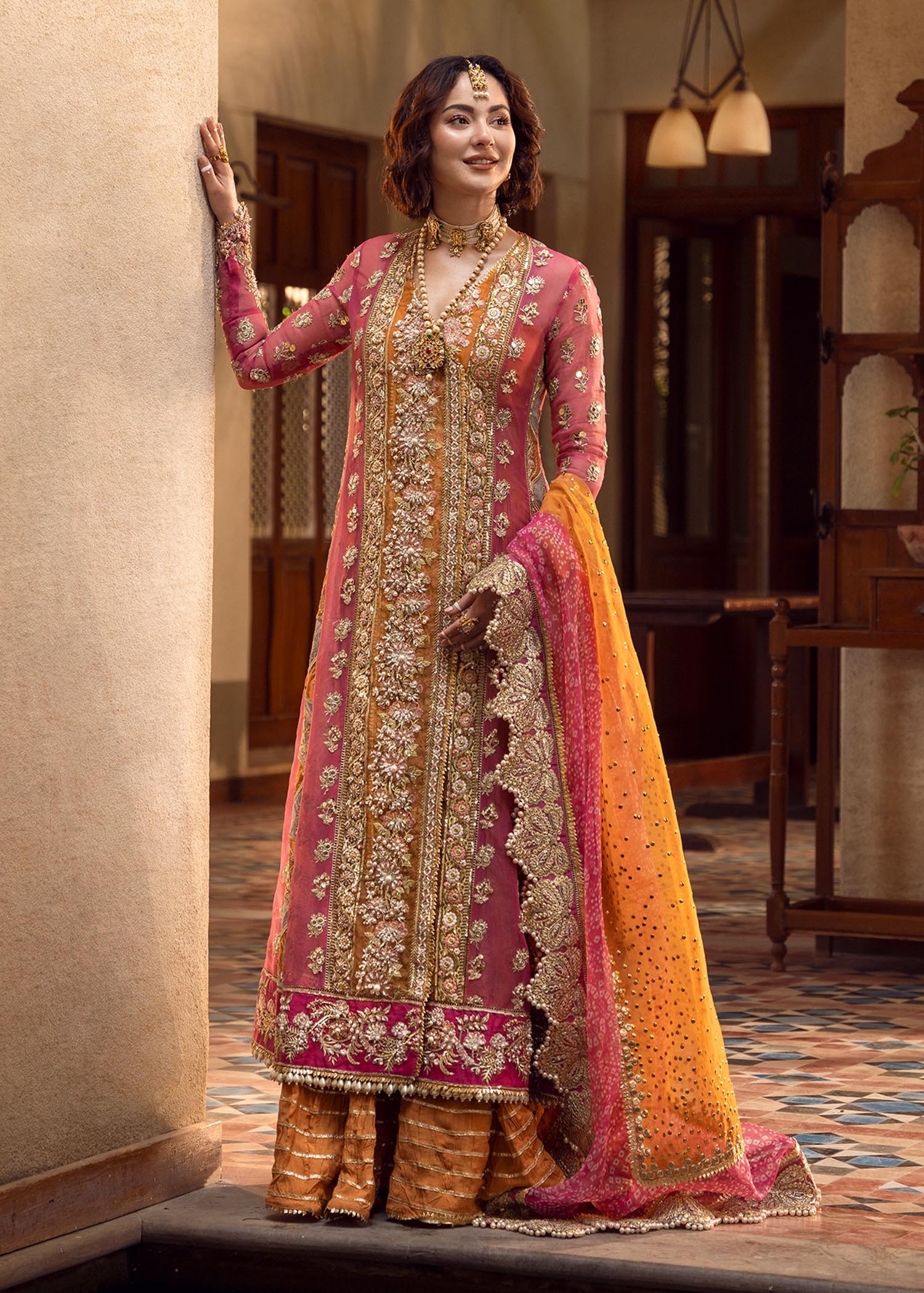 Mehndi Galore pakistani fashion outfit in gold, mustard, orange, pink tones.