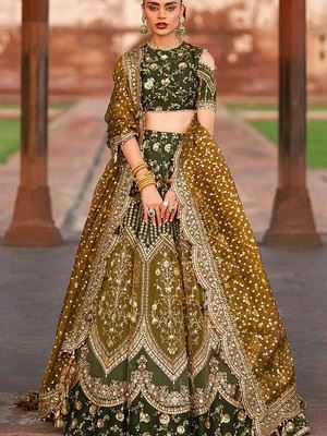 MNR Zarlish - olive green lehenga choli with dense gold embroidery, shot against red sandstone.