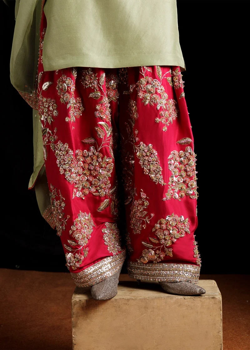 Doron Pakistani fashion outfit in orange, pink, green, silver tones.