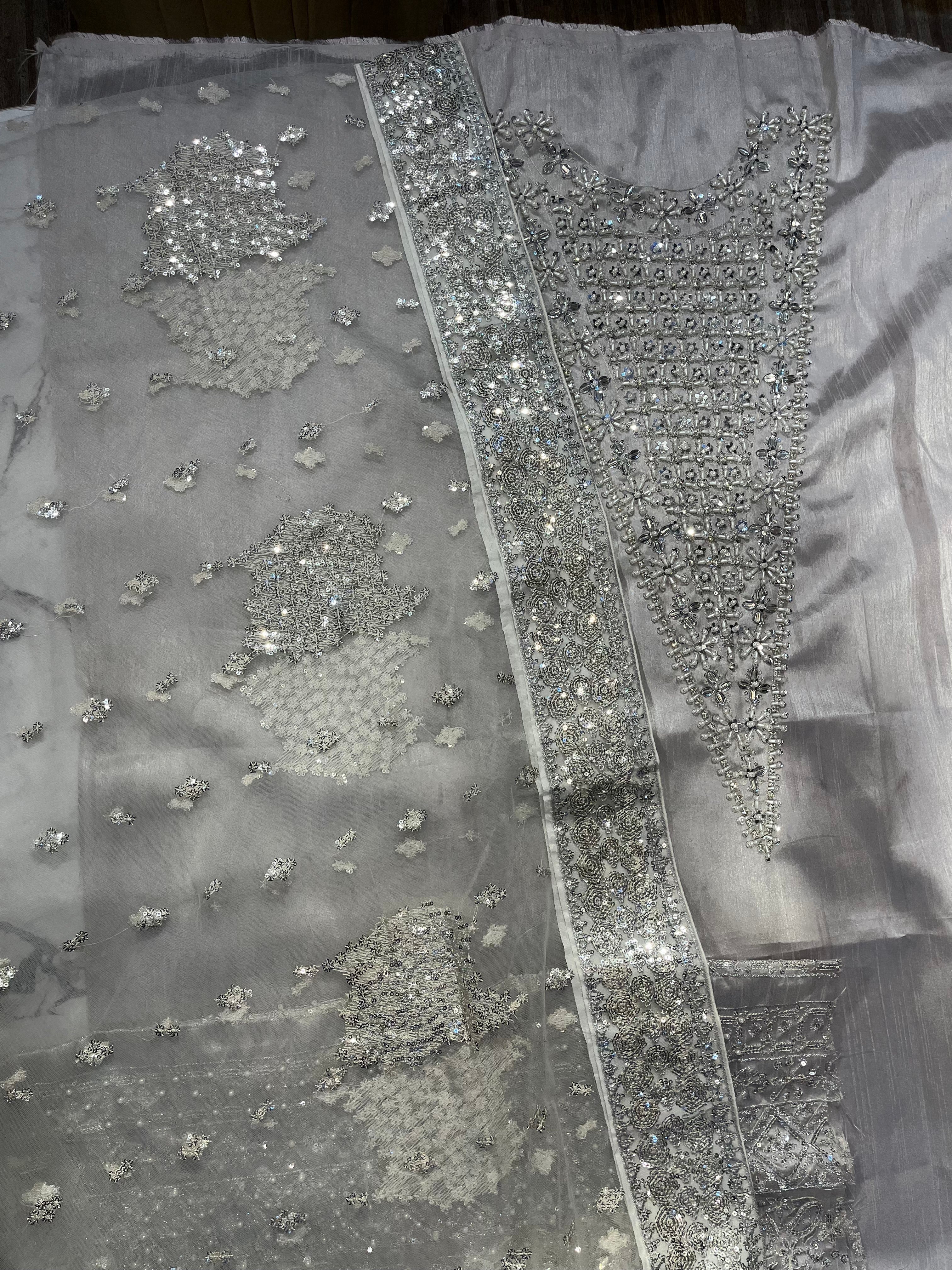 Lucent pakistani fashion outfit in grey, silver tones.