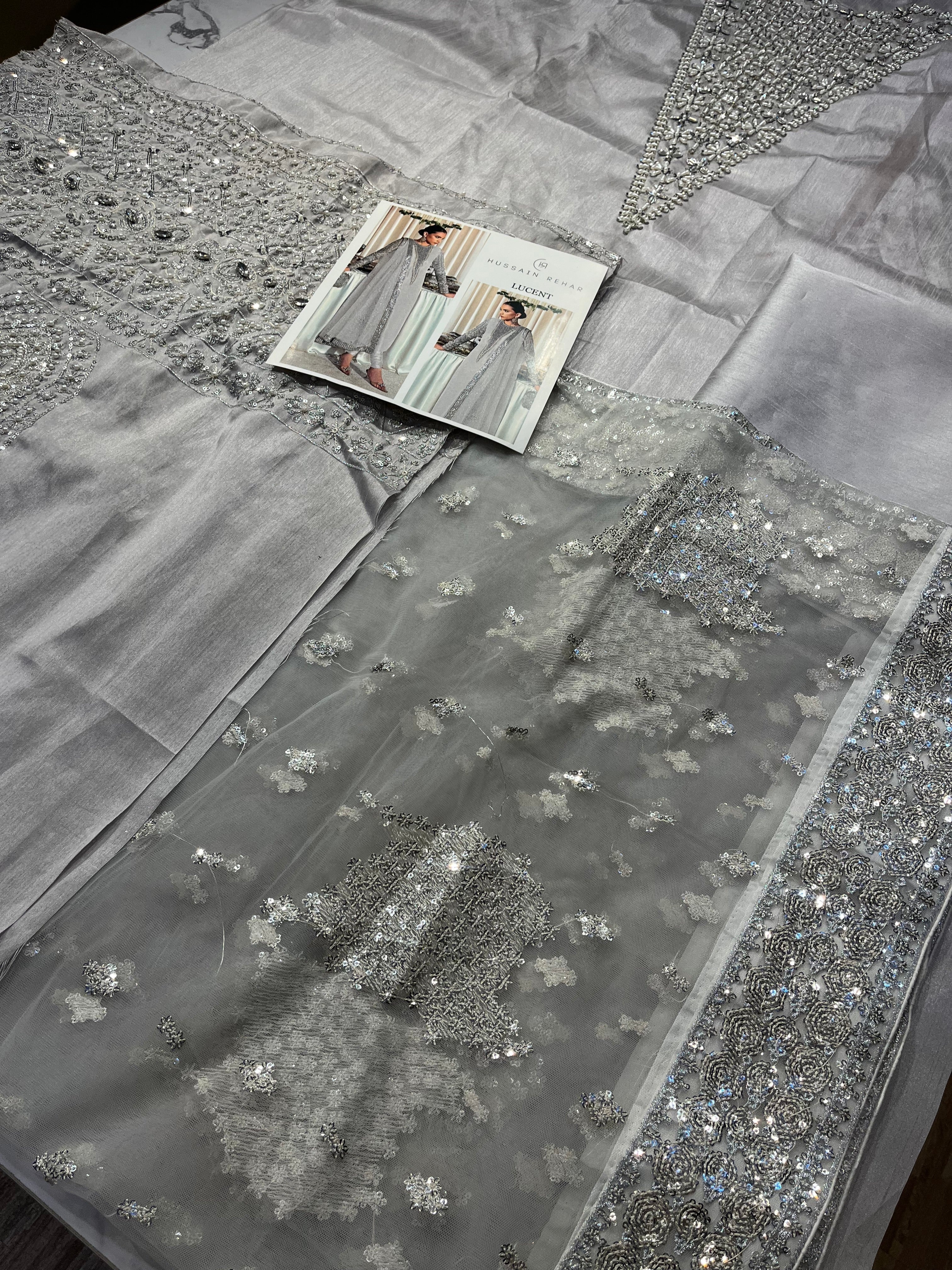 Lucent pakistani fashion outfit in grey, silver tones.
