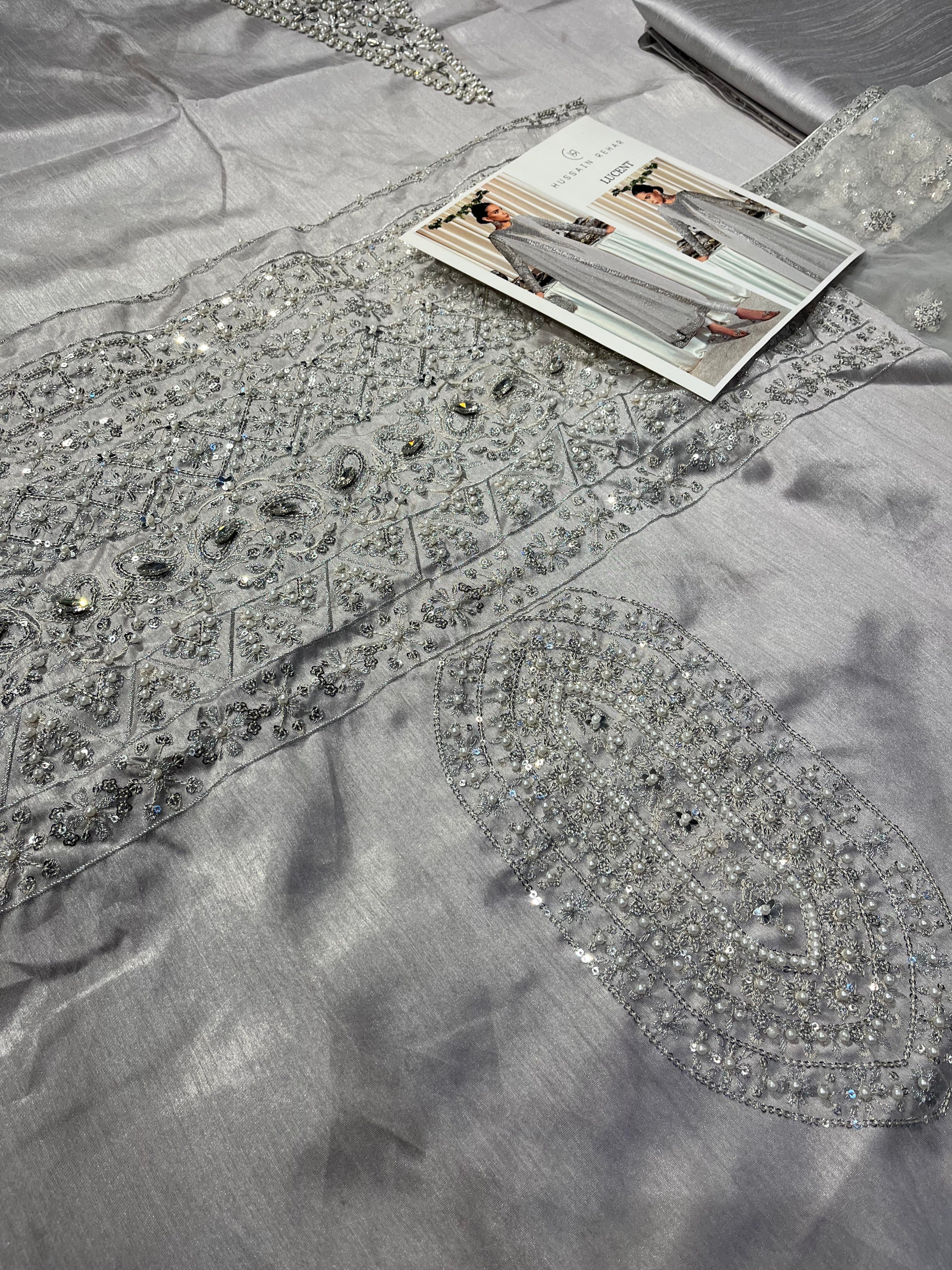 Lucent pakistani fashion outfit in grey, silver tones.
