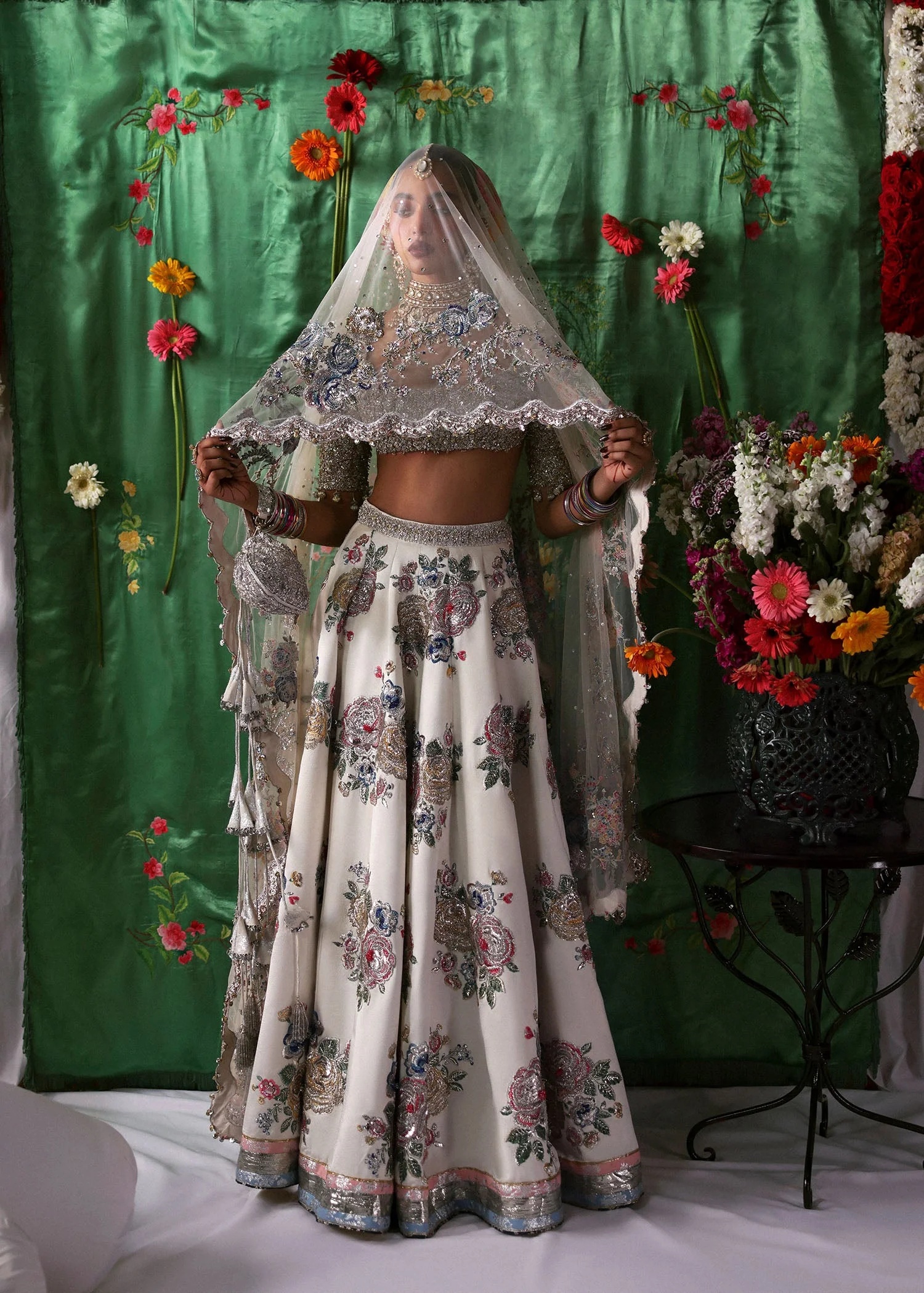 Raks Pakistani fashion outfit in ivory, silver tones.