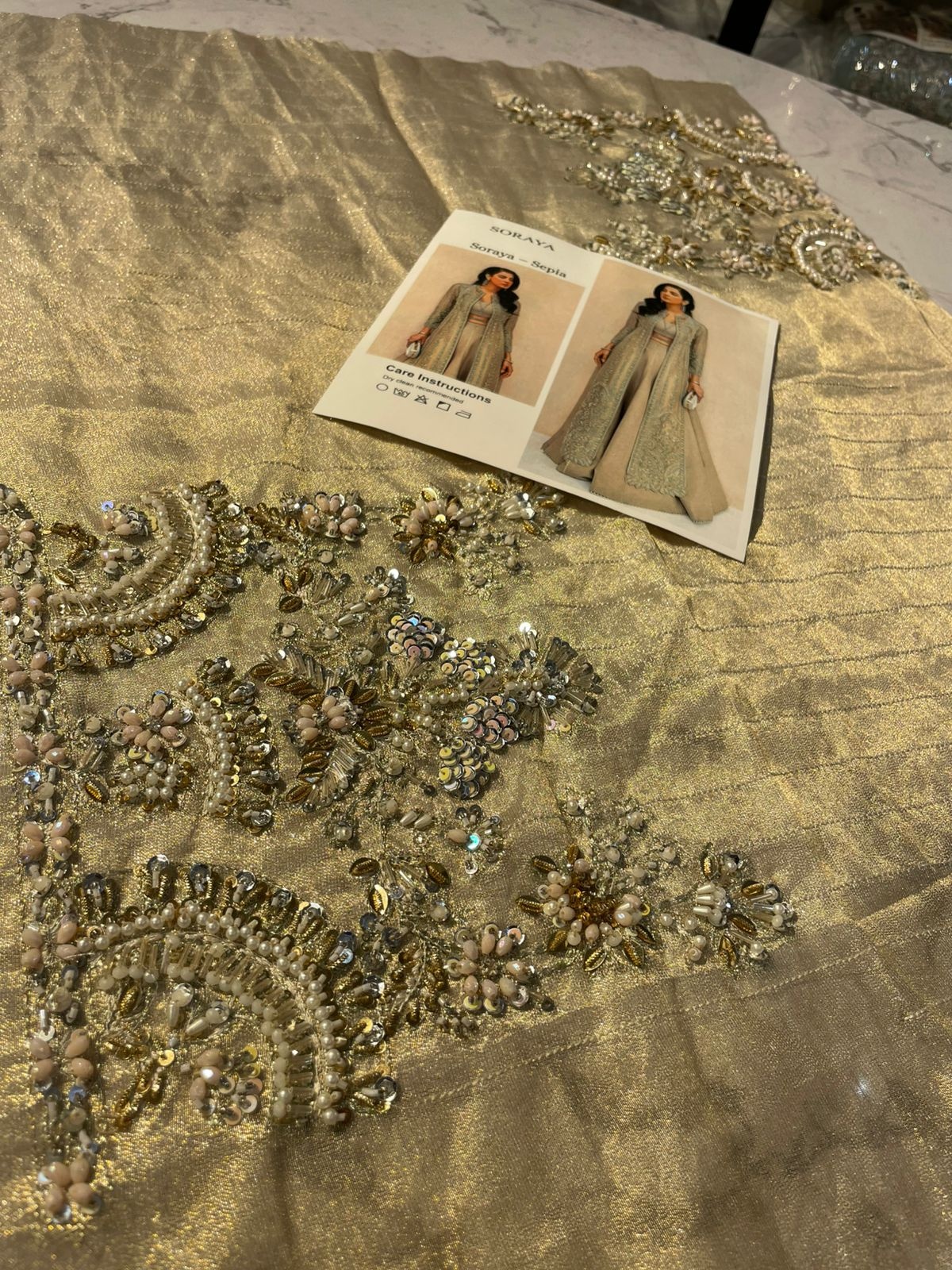 SAPIA pakistani fashion outfit in gold, silver tones.