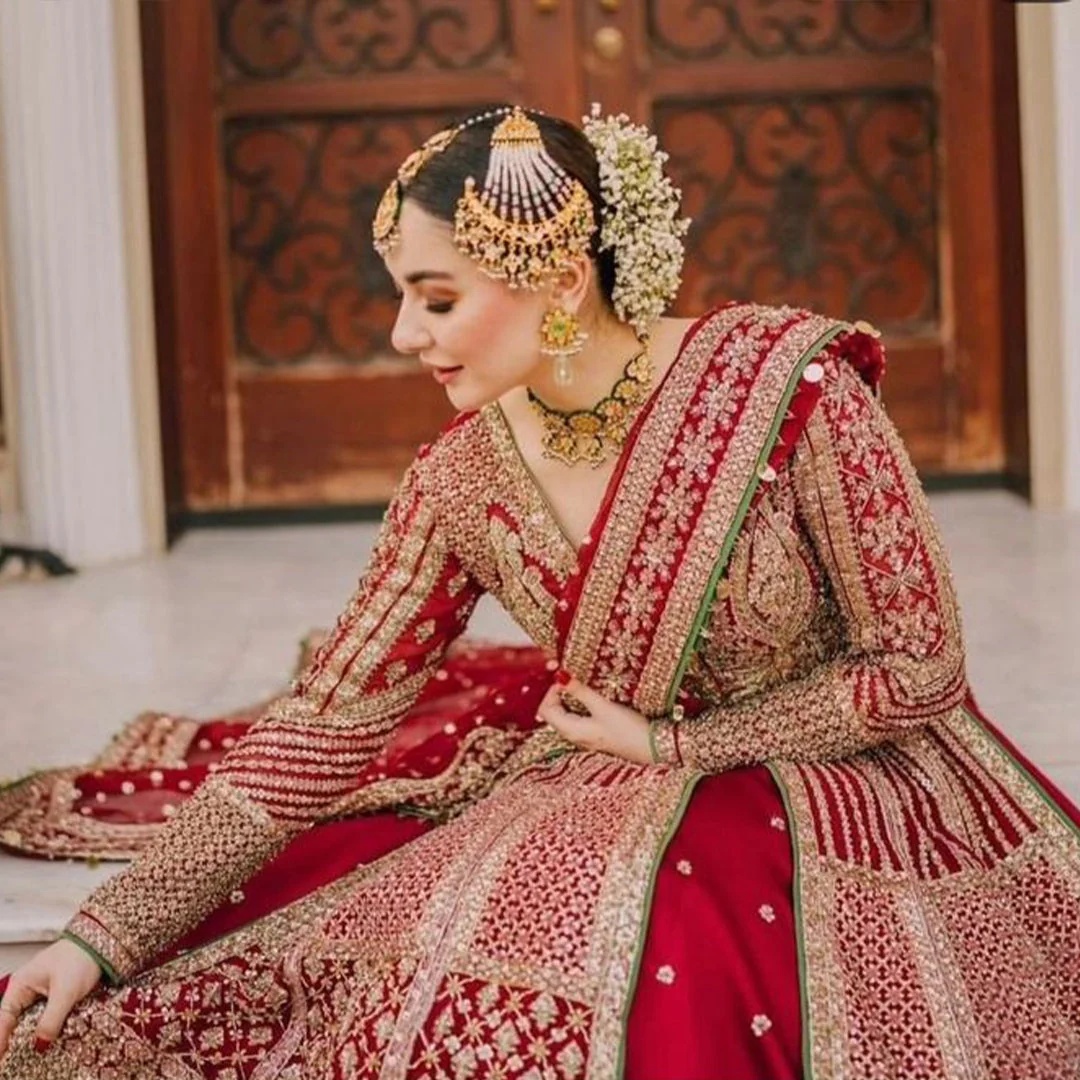 Sarang Pakistani fashion outfit in red, green tones.